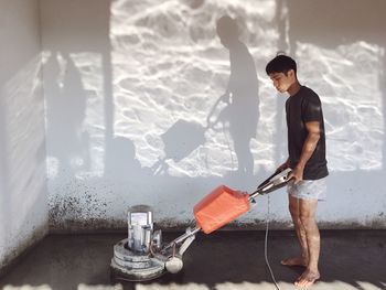 Full length of man holding camera