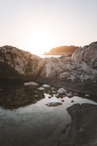 Scenic view of rocks against clear sky