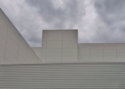 Low angle view of building against cloudy sky