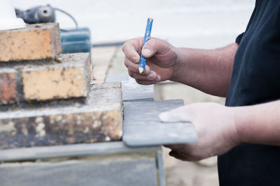 Close-up of man working with pencil