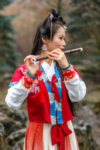 Side view of young woman playing in park