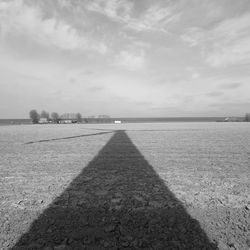 Shadow of landscape against sky