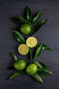 Directly above shot of fruits and leaves on table