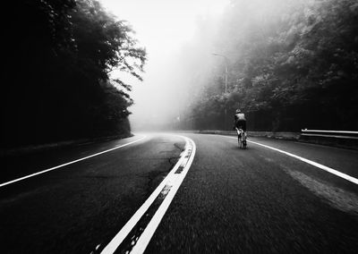 Man riding bicycle on road