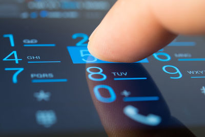 Close-up of hand using smart phone