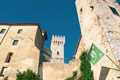 Low angle view of buildings against clear blue sky