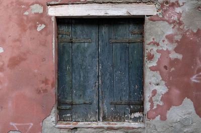 Closed wooden window of old building