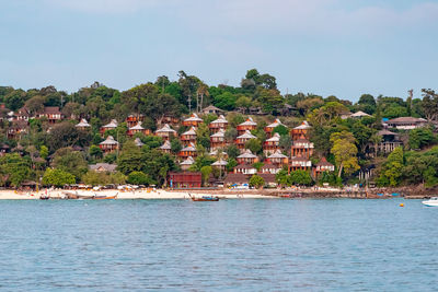 View of townscape by sea against sky