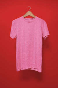 Close-up of pink umbrella against red background