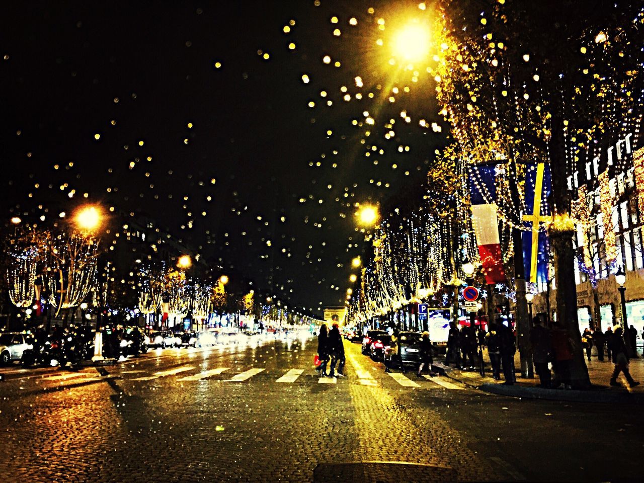 illuminated, night, lifestyles, leisure activity, men, person, street, large group of people, full length, city, city life, walking, lighting equipment, celebration, enjoyment, road, street light, motion