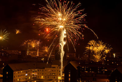 Low angle view of firework display at night