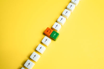 Close-up of toy blocks against yellow background