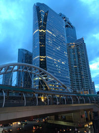 Low angle view of illuminated modern buildings against sky