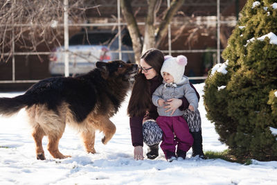 Full length of woman with dog in winter