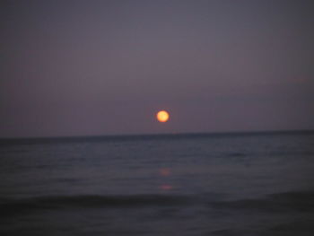 Scenic view of sea against clear sky at night