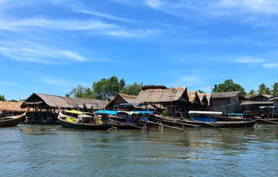 Scenic view of river by building against sky