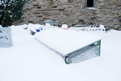 High angle view of snow covered wall by building