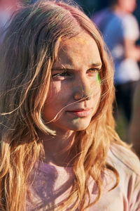 Close-up of teenage girl with powder paint standing outdoors