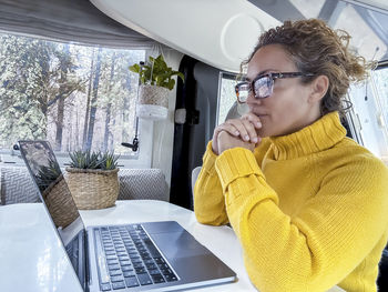 Young woman using laptop at office