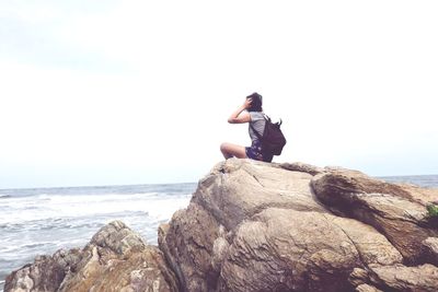 Man looking at sea against sky