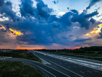 Highway against sky during sunset