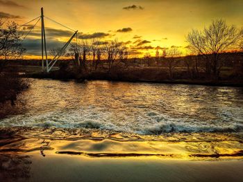 Scenic view of lake against orange sky