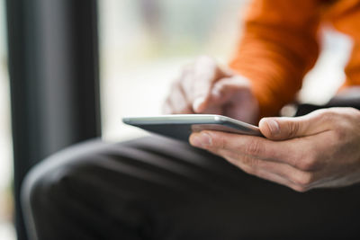 Close-up of man using phablet