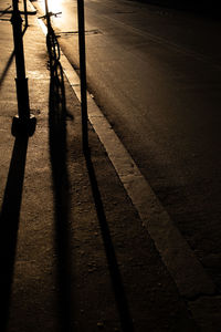 High angle view of shadow on footpath in city