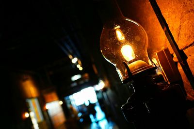 Close-up of lit lamp at night