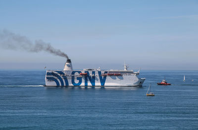 Ship sailing on sea against sky