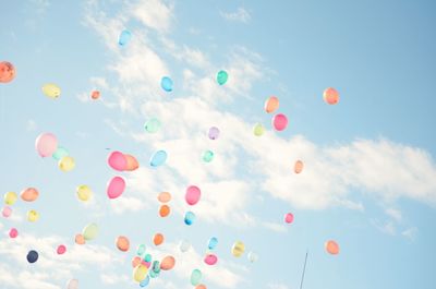 Low angle view of balloons against sky