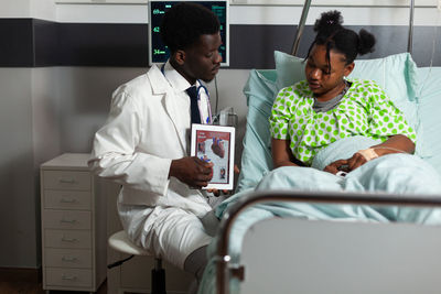 Doctor discussing over tablet pc at hospital