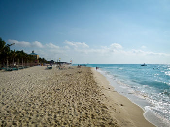 Scenic view of beach against blue sky