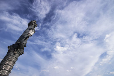 Low angle view of eiffel tower against cloudy sky