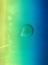 Close-up of water drop on blue sea