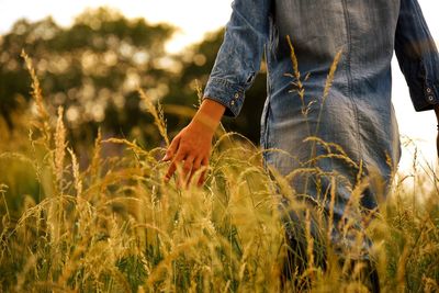 Midsection of man standing on field