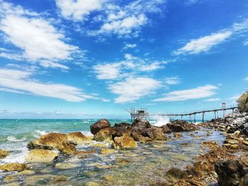 Rocks on beach against sky