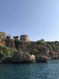 Built structure in sea against clear sky