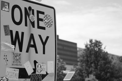 Information sign against sky