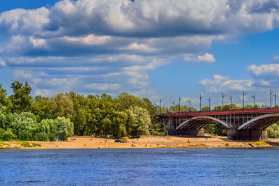 Arch bridge over river against sky