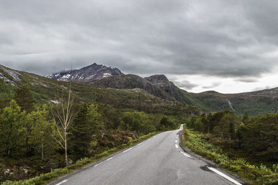 Road amidst mountains against sky