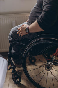 Cropped image of man sitting on wheelchair