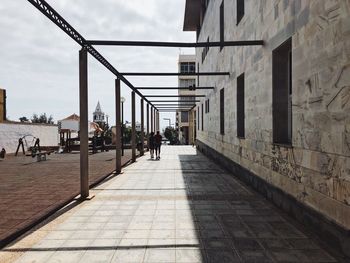 People on street amidst buildings in city