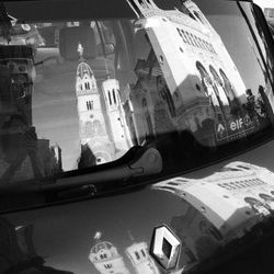 Reflection of buildings in city seen through glass window