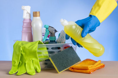 Low section of woman cleaning equipment on table