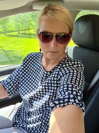 Portrait of smiling young woman sitting in car