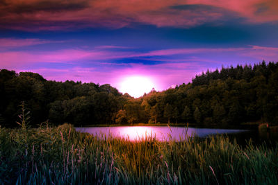 Scenic view of lake against sky at sunset