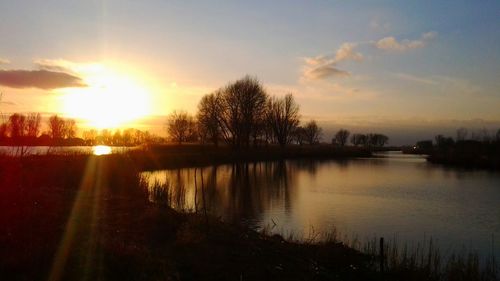 Scenic view of lake against sky during sunset