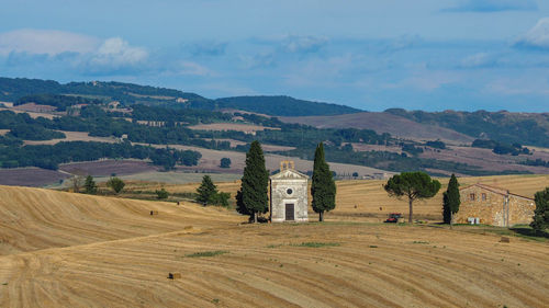 Scenic view of field by mountains against sky
