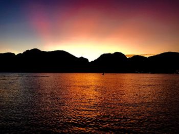 Scenic view of lake against romantic sky at sunset